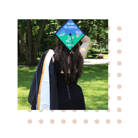 Photo of Hailey in graduation attire with back turned to camera to show cap design